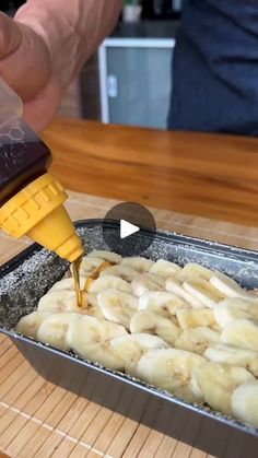 someone is pouring sauce on some bananas in a pan