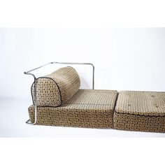 a couch that is made out of wicker and metal frame, with the seat folded down