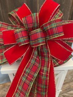 a red and green plaid bow on a white chair