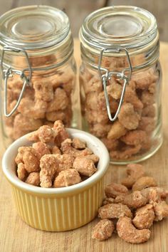 two jars filled with food sitting on top of a wooden table