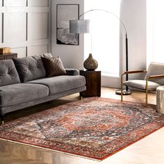 a living room filled with furniture and a large rug