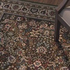 a chair and rug in a room with wooden floors