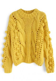 a yellow knitted sweater with ruffled sleeves and an openwork design on the front