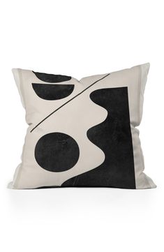 a black and white pillow sitting on top of a table