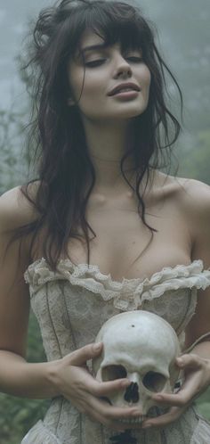 a woman with long hair holding a skull in front of her face and wearing a corset