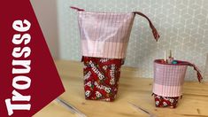 two bags with candy on them sitting on top of a wooden table