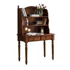 a wooden desk with a book shelf on top of it and flowers in a vase