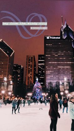 people skating on an ice rink in front of tall buildings at night with the city lights lit up