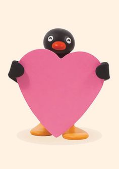 a penguin holding a pink heart on top of it's legs with its arms