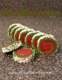 several green and red cookies with white sprinkles on the top are stacked together