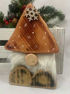 a wooden gnome with a snowflake on his hat