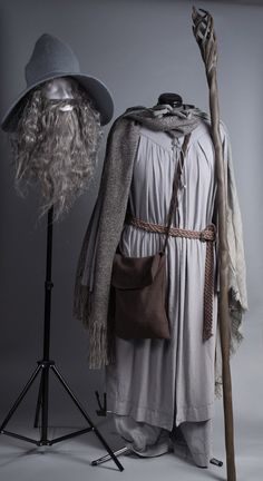 an old man's costume and hat on display in front of a gray background