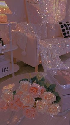 a living room filled with white furniture and lots of lights on the wall above it