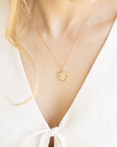 Indulge in celestial vibes with our Celeste Necklace. The gold medallion coin adds a touch of old money luxury while the celestial stone detailing adds a mystical touch. Perfect for adding a touch of gold to any outfit. Details: -Gold Filled -18" length -Waterproof, tarnish free, hypoallergenic -Bright White CZ Stones Gold-tone Medallion Necklace With Coin Pendant, 14k Gold Spiritual Coin Necklace With Round Pendant, Gold Plated Coin Pendant Jewelry, Spiritual Gold-plated Coin Pendant Jewelry, Elegant Gold Medallion Coin Necklace, Moon Phase Medallion Amulet Jewelry, Elegant Medallion Necklace With Coin Pendant, Spiritual Gold-plated Medallion Necklace With Round Pendant, Spiritual Gold Plated Round Medallion Necklace