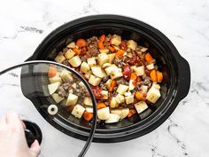 the food is being cooked in the slow cooker