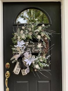 a black door with a wreath on it that says, love is in the air