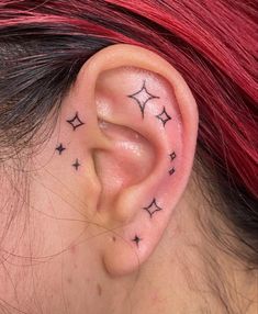 a woman's ear with stars on it