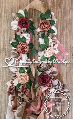 the paper flowers are arranged on top of each other, and tied together with ribbon