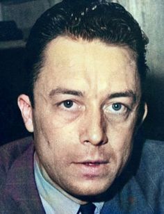 a close up of a person wearing a suit and tie with an intense look on his face