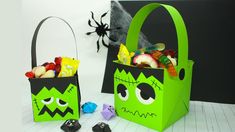 two halloween bags with candy in them on a table