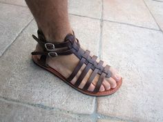 Men's comfortable and high quality sandals made from genuine cowhide leather in brown color. Strong and durable gladiator sandals also featuring stitched leather insoles, double buckle closures and slip resistant rubber soles. Please check below for correct size. EU=40 (26.5cm)UK=6US=7 EU=41 (27cm)UK=7US=8 EU=42 (27.5cm)UK=8US=9 EU=43 (28.5cm)UK=9US=10 EU=44 (29cm)UK=10US=11 EU=45 (29.5cm)UK=11US=12 EU=46 (30cm)UK=12US=13 EU=47 (30.5cm)UK=13US=14 Orders are shipped by registered mail with tracki Rugged Brown Sandals For Summer, Brown Rugged Sandals For Summer, Rugged Brown Summer Sandals, Leather T-strap Double Strap Sandals For Summer, Brown Rugged Open Toe Sandals, Leather Thread For Roman Sandals, Adjustable Double Strap Leather T-strap Sandals, Brown Leather Footbed T-strap Sandals, Men’s Gladiator Sandals