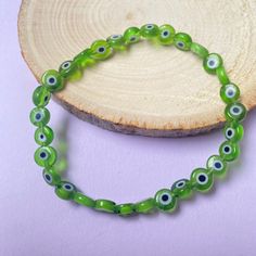 the eye amulet is believed to protect those who wear it from negative energy. reflecting said energy back to sender.  these bracelets are handcrafted in san antonio, tx with the intention of protection! Green Beaded Evil Eye Bracelet For Gifts, Green Spiritual Evil Eye Bracelet As Gift, Green Beaded Bracelets With Evil Eye For Gift, Adjustable Green Evil Eye Bracelet, Adjustable Green Evil Eye Bracelets, Green Evil Eye Bracelet With Round Beads As Gift, Green Evil Eye Bracelet With Round Beads, Spiritual Round Evil Eye Bracelet, Adjustable Green Evil Eye Spiritual Bracelet