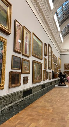 an art gallery with many paintings on the wall