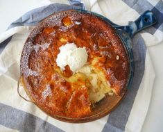 a pie with ice cream on top sitting on a blue and white checkered table cloth