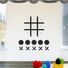 the wall is decorated with black and white crosses on it's walls, along with colorful blocks