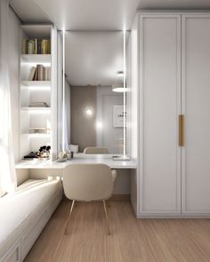 a room with white walls and wooden flooring next to a desk in front of a book shelf