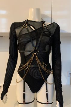 Leather harnesses for women in black with gold chain accessories Villain Aesthetic Outfits Women, Black Harness Outfit, Outfits With Harness, Leather Playsuit, Body Harness Outfits, Slave Outfit, Harness Outfit, Leg Garters