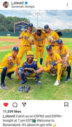 a group of baseball players posing for a photo on the field with their arms around each other