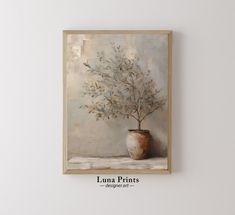 an oil painting of a potted plant on a wall above a white table with the words luna prints written below it