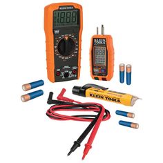 an assortment of electrical tools including multimeters and wires