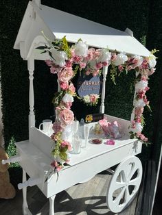 a white cart with flowers and candles on it