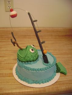 a cake that is shaped like a fish with a fishing hook on it's head