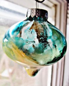 a glass ornament hanging from a window sill