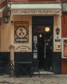 the entrance to a bar called la gifiana in an old european town, with tables and chairs outside