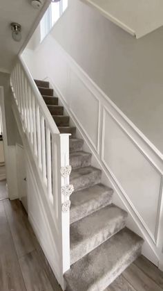 a staircase with carpeted steps and white railing