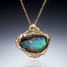 Gold & Stone Necklace - A gorgeous brilliantly-colored freeform boulder opal is encircled in a 14k yellow gold one-of-a-kind setting. The pendant hangs from a 16-1/2 diamond-cut Figaro chain with a lobster clasp closure. Wire Wrapped Jewelry Pendant, Boulder Opal Jewelry, Gold Stone Necklace, Boulder Opal Pendant, Rainbow Moonstone Necklace, Gold Rings Jewelry, Gem Necklace, Artful Home, Figaro Chain