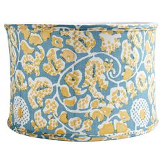 a blue and yellow lamp shade with flowers on it