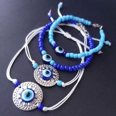 Evil eye adjustable bracelet,Beaded evil eye,Tiny evil eye,Evil eye bracelet, Evil eye earring,Good luck gifts,Tiny eye,Blue evil,Greek evil ----- For the set Please message in dark blue or light blue---- Adjustable evil eye bracelet- Rope bracelet Silver plated earrings Seed bead acrylic evil eye Natural seashell Blue Adjustable Evil Eye Bracelet, Blue Metal Bracelet With Evil Eye, Beaded Evil Eye, Affordable Adjustable Hand-strung Evil Eye Bracelet, Adjustable Blue Hand-strung Evil Eye Bracelet, Blue Bohemian Evil Eye Bracelet Hand-strung, Bracelet Rope, Eye Natural, Cool Rings For Men