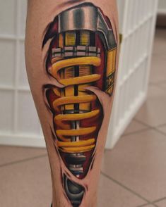 a man's leg with a tattoo on it that has an image of a train coming out of the engine