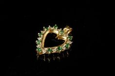 This is a very beautiful, unique and vintage EMERALD DIAMOND 10K GOLD pendant (weight 2.2g) The pendant has a delightful heart shape with emeralds (1.5 mm), tiny diamonds and 10K yellow gold (bottom has 10K). It measures 15/16" x 11/16". The pendant is in very good condition. 0.7  GLM Heart Cut Emerald Jewelry For May Birthstone, Heart-shaped Emerald Jewelry With Birthstone, Heart-shaped Emerald Birthstone Jewelry, Collectible Green 14k Stamped Jewelry, Heart-shaped Emerald Jewelry For Valentine's Day, Gold Emerald Heart Pendant Jewelry, Emerald Heart Charm Jewelry, Heart-shaped Emerald Jewelry For May Birthstone, Fine Jewelry Heart Pendant For May Birthstone