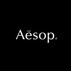 the aesop logo is shown on a black background with white letters in front of it