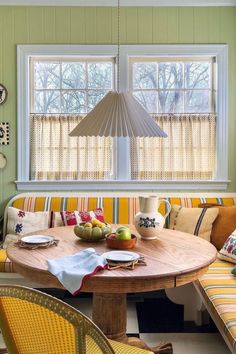 a table with fruit on it in the middle of a room next to a couch