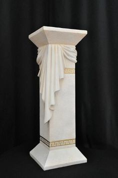 a white marble statue with gold trimmings