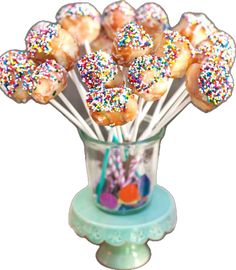 a glass vase filled with donuts covered in sprinkles