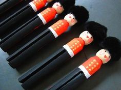 five black and orange dolls are lined up on top of each other in the shape of people's heads