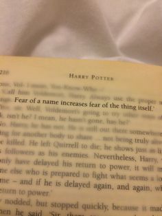 an open harry potter book with the title written in english on it's page